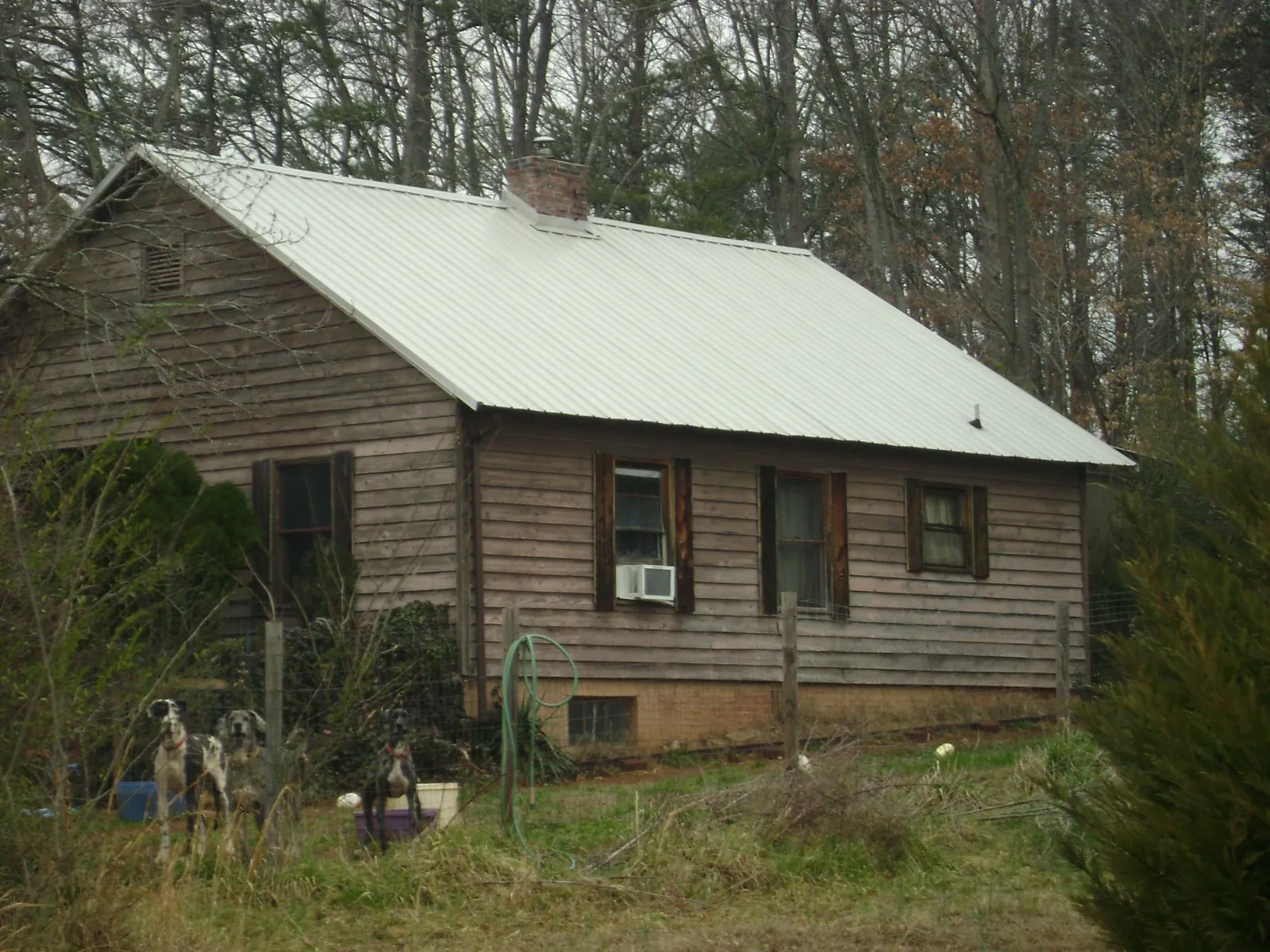 White metal roof on an old wood sided farmhouse, from a Metal Roof Installation job in Butler